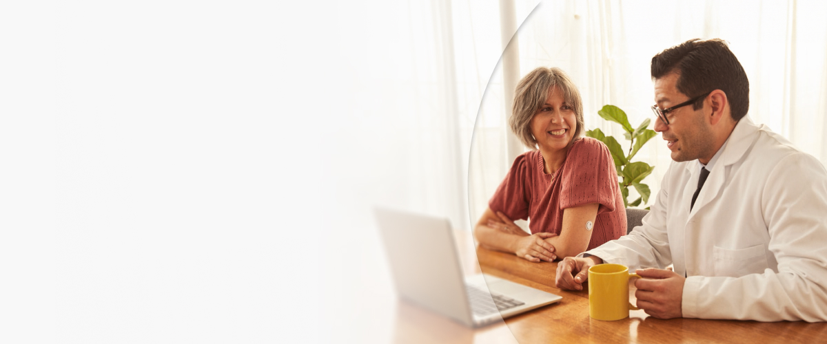 Woman wearing a FreeStyle Libre systems sensor speaking to her doctor