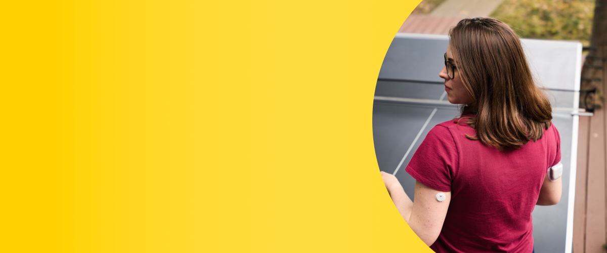 Woman playing table tennis while wearing a FreeStyle Libre 3 Plus sensor