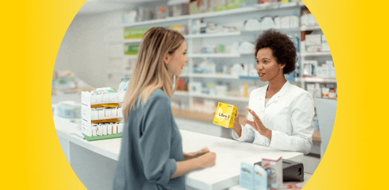 Woman speaking to her pharmacist about FreeStyle Libre 3 Plus sensors